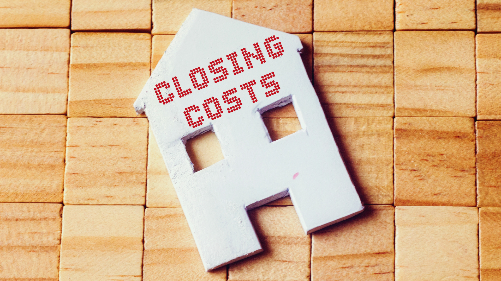 a cut-out of a house with "closing cost" text